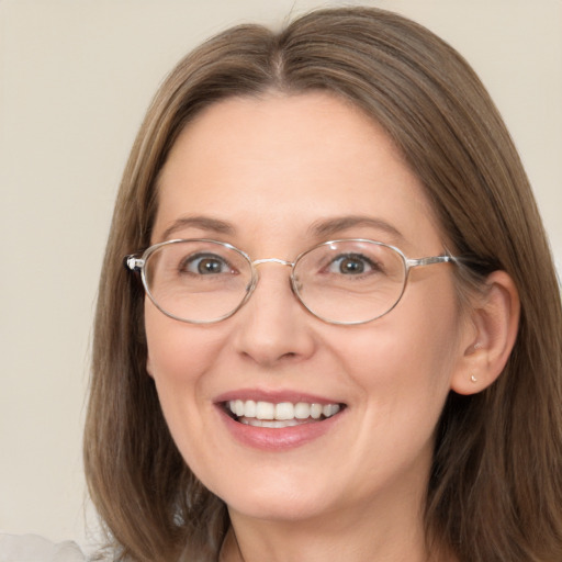 Joyful white adult female with long  brown hair and brown eyes