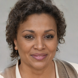 Joyful black adult female with short  brown hair and brown eyes