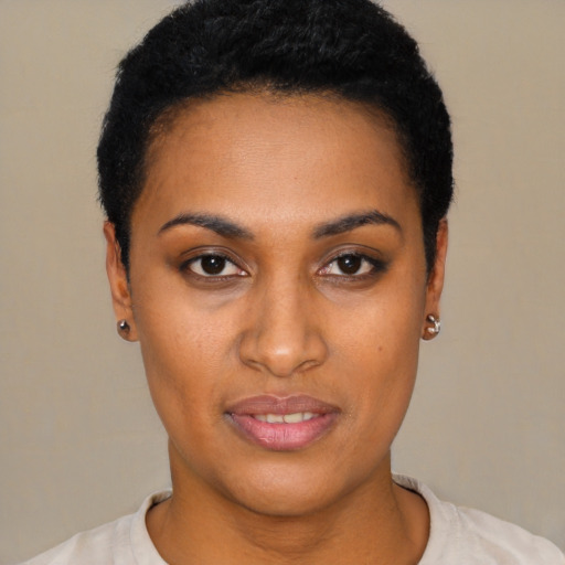 Joyful black young-adult female with short  black hair and brown eyes