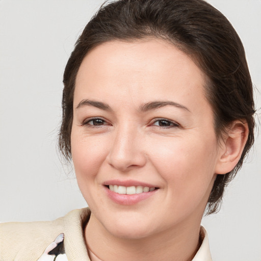 Joyful white young-adult female with medium  brown hair and brown eyes