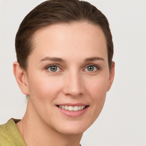 Joyful white young-adult female with short  brown hair and grey eyes