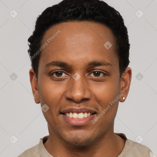 Joyful black young-adult male with short  black hair and brown eyes