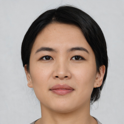 Joyful asian young-adult female with short  black hair and brown eyes