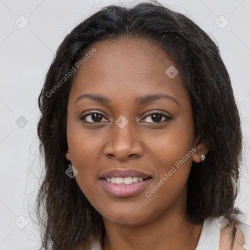 Joyful black young-adult female with long  brown hair and brown eyes