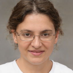 Joyful white adult female with medium  brown hair and brown eyes