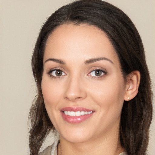 Joyful white young-adult female with long  brown hair and brown eyes