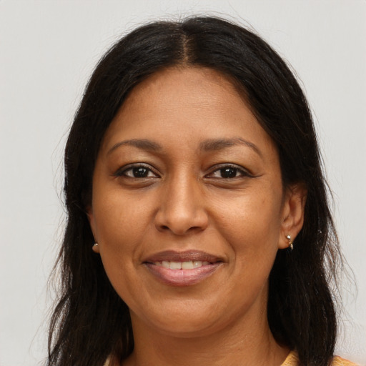 Joyful latino adult female with long  brown hair and brown eyes