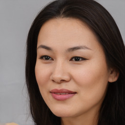 Joyful asian young-adult female with long  brown hair and brown eyes