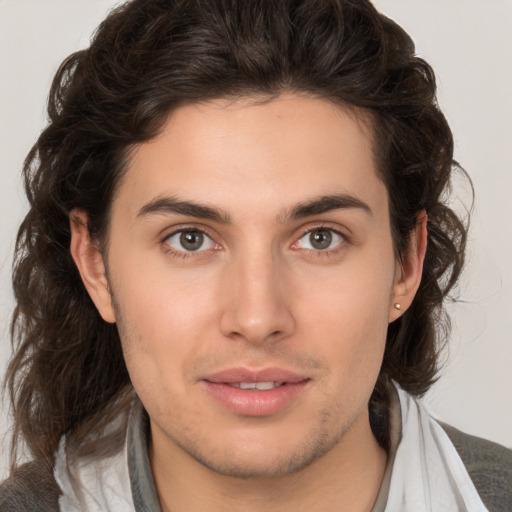 Joyful white young-adult male with medium  brown hair and brown eyes