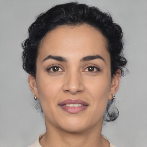 Joyful latino young-adult female with medium  black hair and brown eyes
