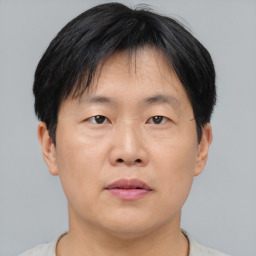 Neutral asian young-adult male with short  brown hair and brown eyes