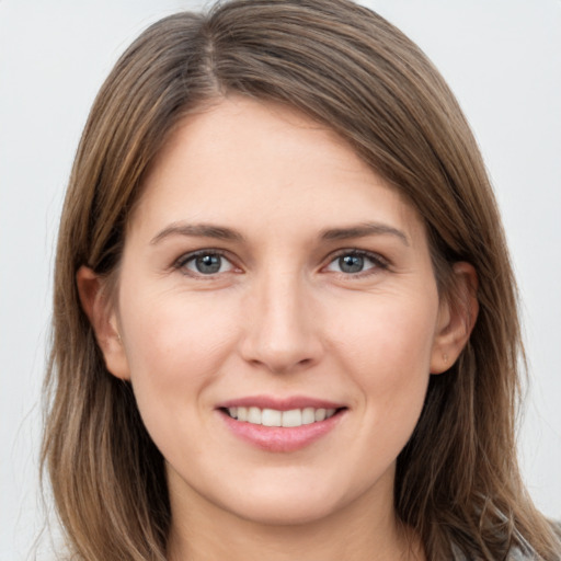 Joyful white young-adult female with long  brown hair and grey eyes