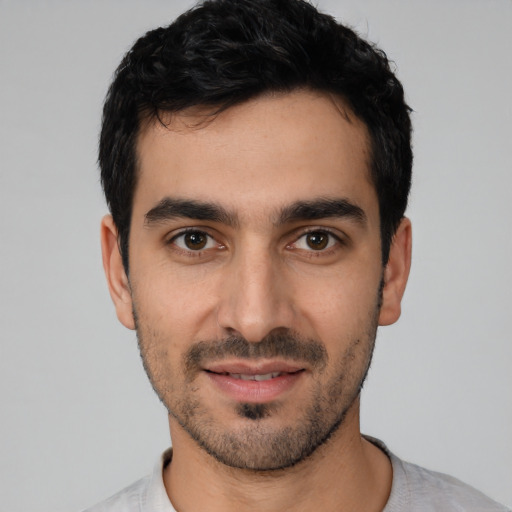 Joyful white young-adult male with short  black hair and brown eyes