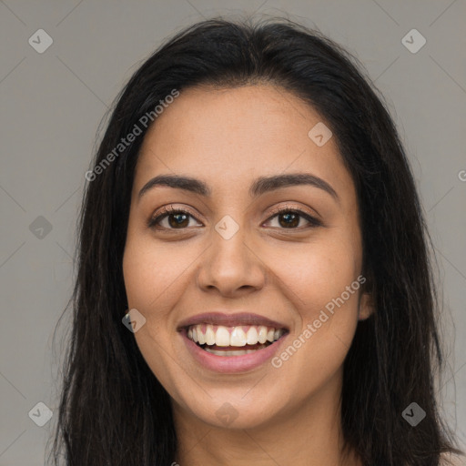 Joyful latino young-adult female with long  brown hair and brown eyes