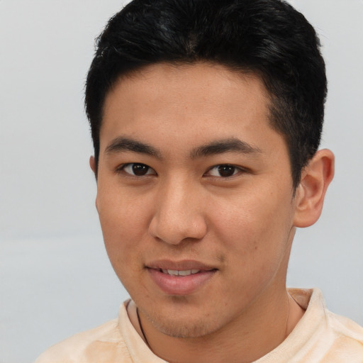 Joyful asian young-adult male with short  black hair and brown eyes