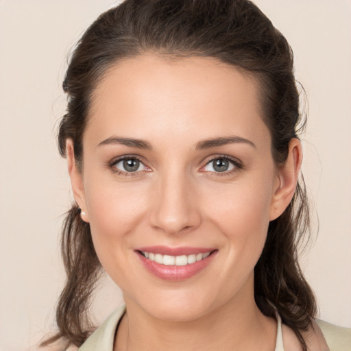 Joyful white young-adult female with medium  brown hair and brown eyes