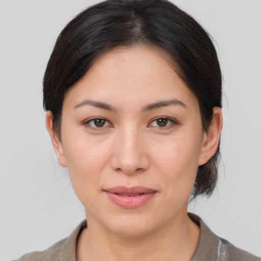 Joyful asian young-adult female with medium  brown hair and brown eyes