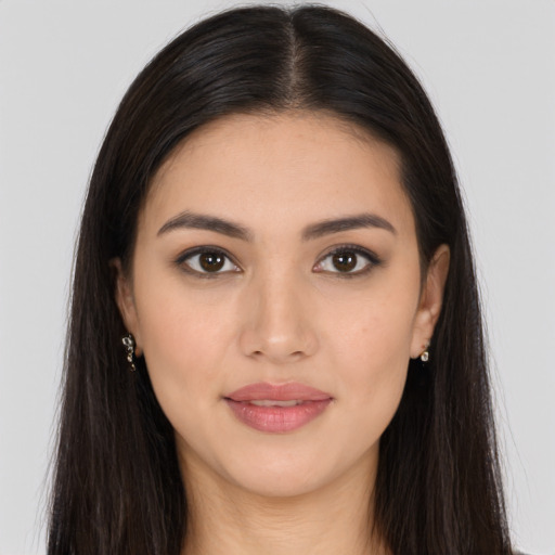 Joyful latino young-adult female with long  brown hair and brown eyes