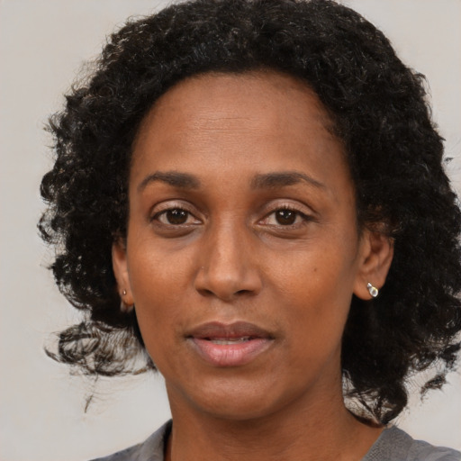 Neutral black adult female with medium  black hair and brown eyes