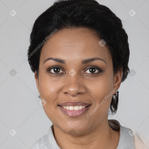 Joyful black young-adult female with short  black hair and brown eyes