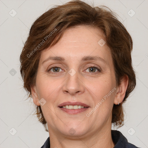 Joyful white adult female with medium  brown hair and grey eyes