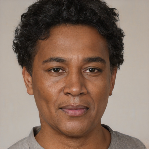 Joyful latino adult male with short  black hair and brown eyes