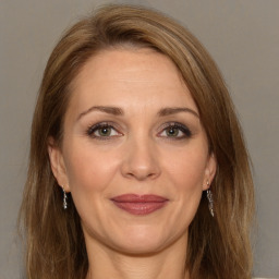 Joyful white adult female with long  brown hair and brown eyes