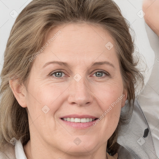 Joyful white adult female with medium  brown hair and grey eyes