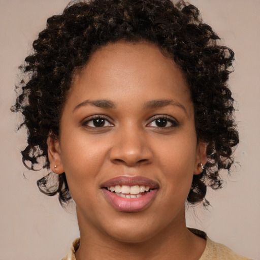 Joyful black young-adult female with medium  brown hair and brown eyes