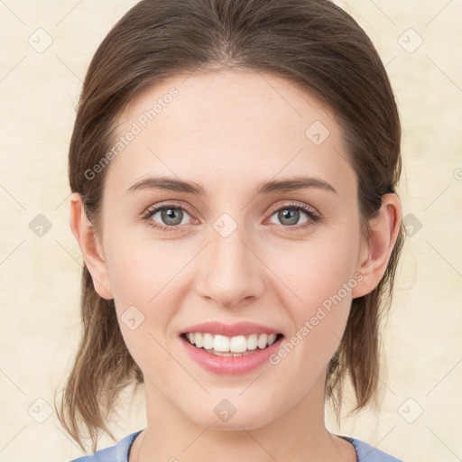 Joyful white young-adult female with medium  brown hair and green eyes