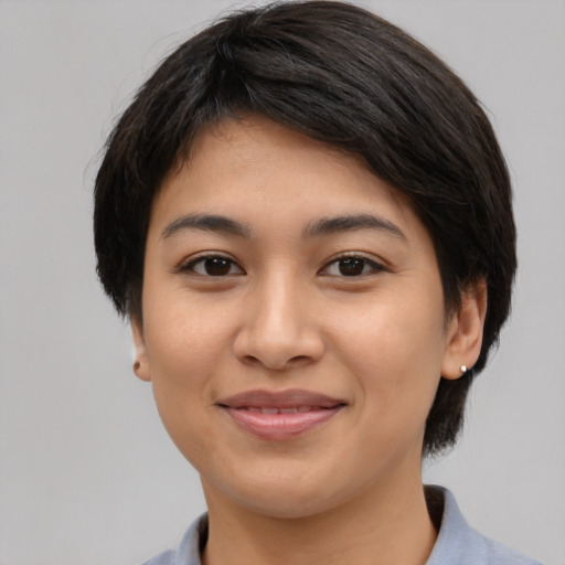 Joyful latino young-adult female with medium  black hair and brown eyes