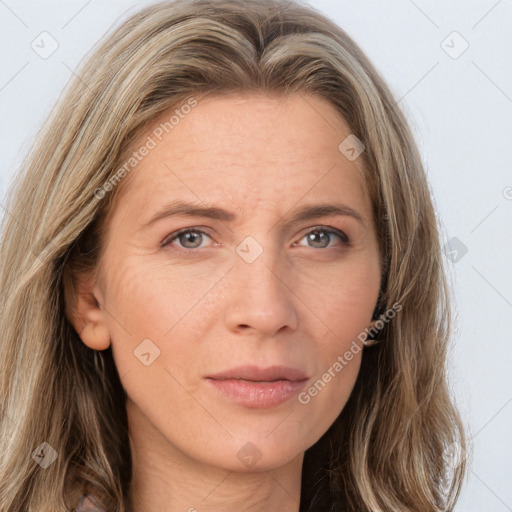 Joyful white adult female with long  brown hair and grey eyes