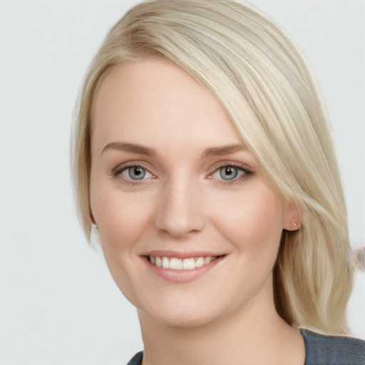 Joyful white young-adult female with medium  brown hair and blue eyes