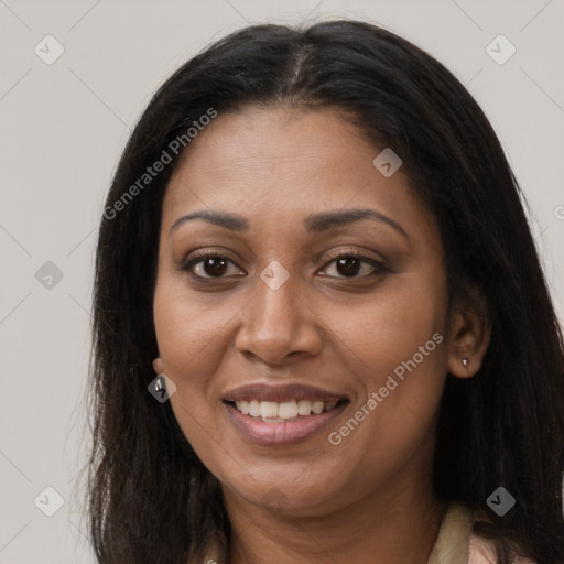 Joyful black young-adult female with long  brown hair and brown eyes