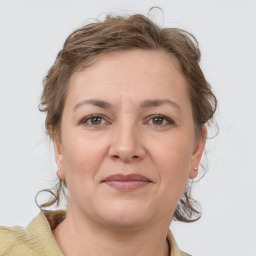 Joyful white adult female with medium  brown hair and grey eyes