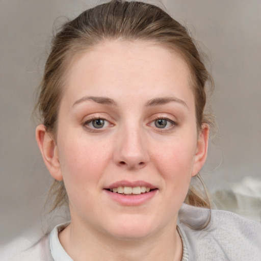 Joyful white young-adult female with medium  brown hair and blue eyes