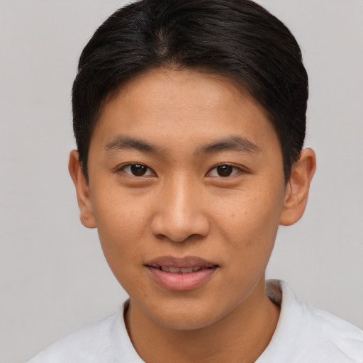 Joyful asian young-adult female with short  brown hair and brown eyes