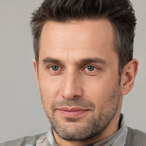 Joyful white adult male with short  brown hair and brown eyes