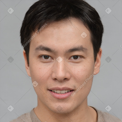 Joyful asian young-adult male with short  brown hair and brown eyes