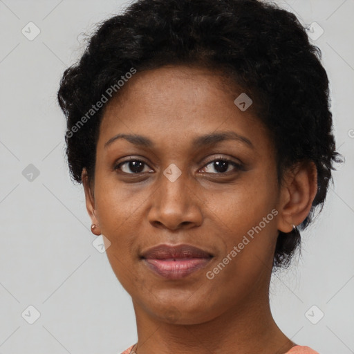 Joyful black young-adult female with short  black hair and brown eyes