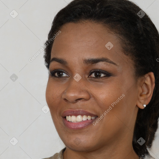 Joyful black young-adult female with medium  brown hair and brown eyes