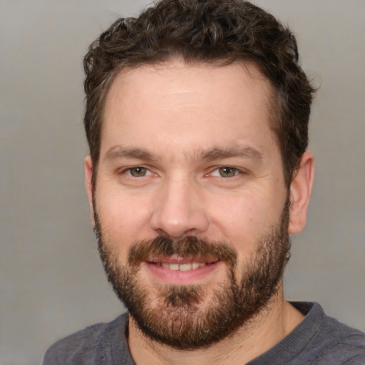 Joyful white adult male with short  brown hair and brown eyes