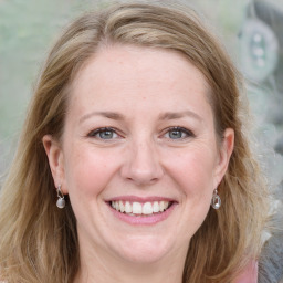 Joyful white young-adult female with medium  brown hair and blue eyes