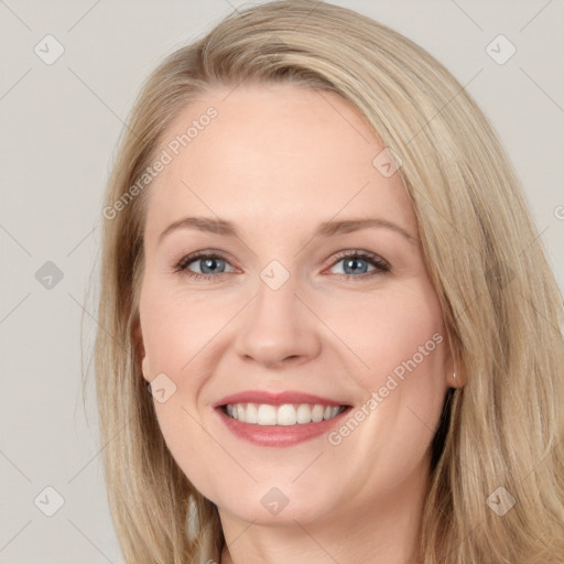 Joyful white young-adult female with long  brown hair and blue eyes