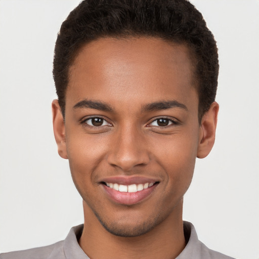 Joyful black young-adult male with short  brown hair and brown eyes