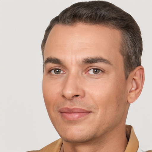 Joyful white adult male with short  brown hair and brown eyes