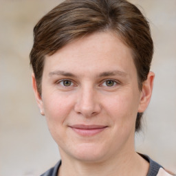 Joyful white adult female with short  brown hair and grey eyes