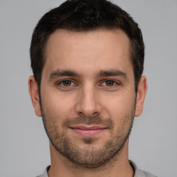 Joyful white young-adult male with short  brown hair and brown eyes