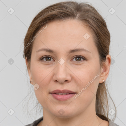 Joyful white adult female with medium  brown hair and grey eyes