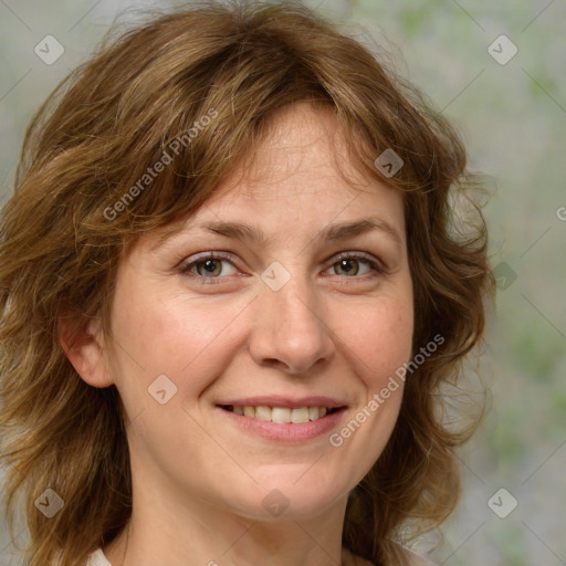 Joyful white adult female with medium  brown hair and blue eyes